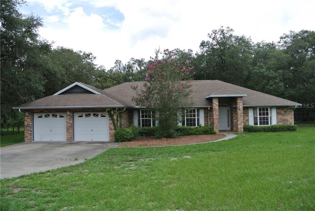 9817 Carr Road Riverview, FL 33569 - Photo 1 of 1 a front view of a house with a yard and trees