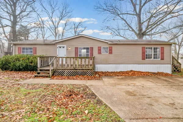 a view of a house with a yard covered with snow