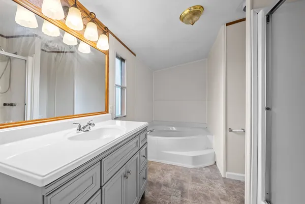 a bathroom with a sink a toilet a tub and shower