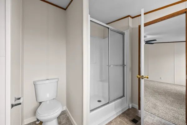 a bathroom view of a toilet and a shower