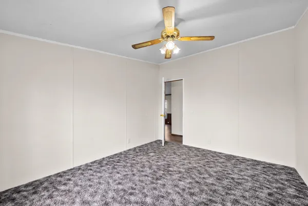 a view of a room with a sink and chandelier fan