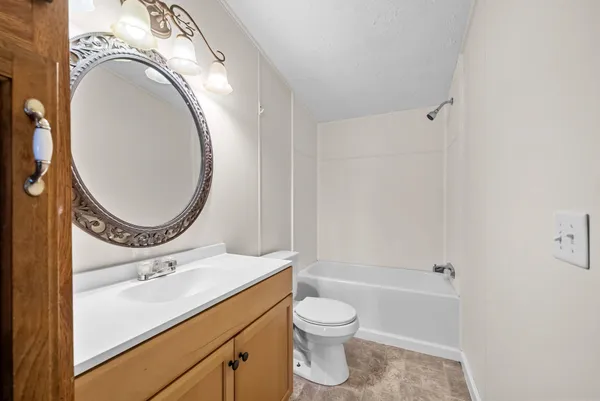 a bathroom with a toilet a sink and a mirror