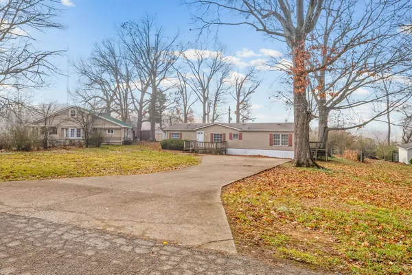 a view of white house with a large trees