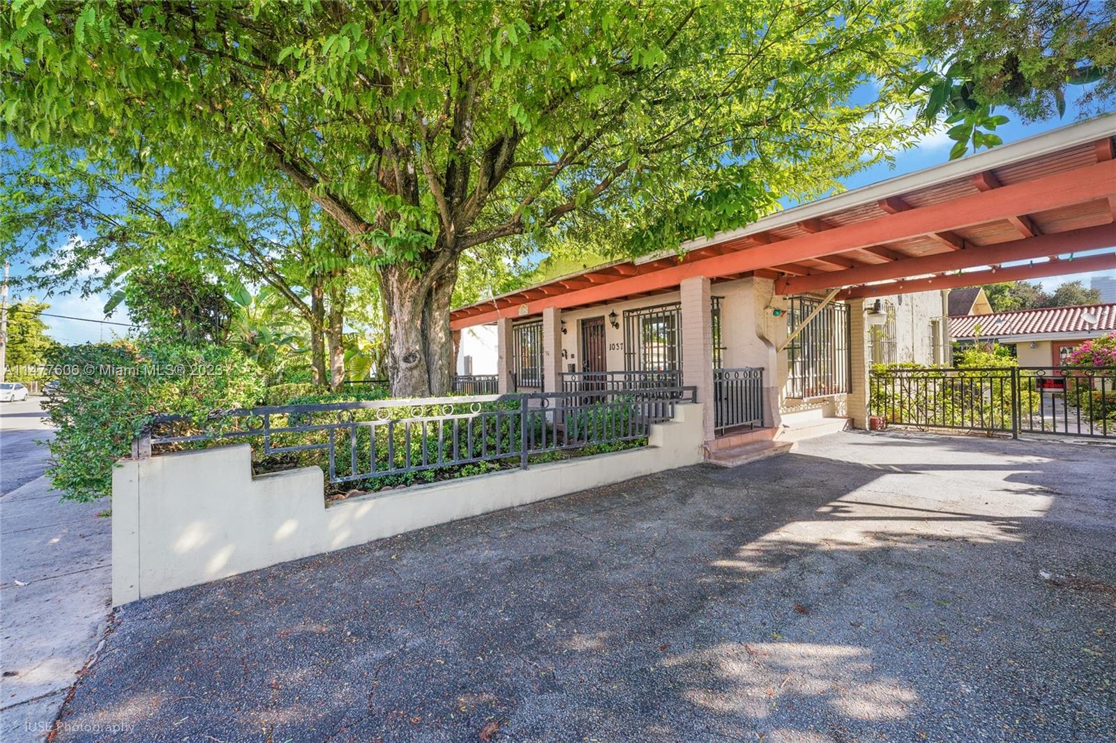a view of a house with a yard and potted plants