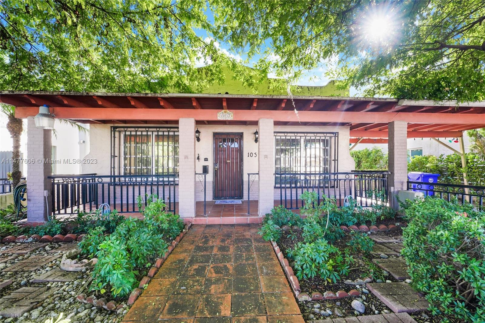 1037 Southwest 10th Avenue Miami, FL 33130 - Photo 2 of 19 a front view of a house with a garden