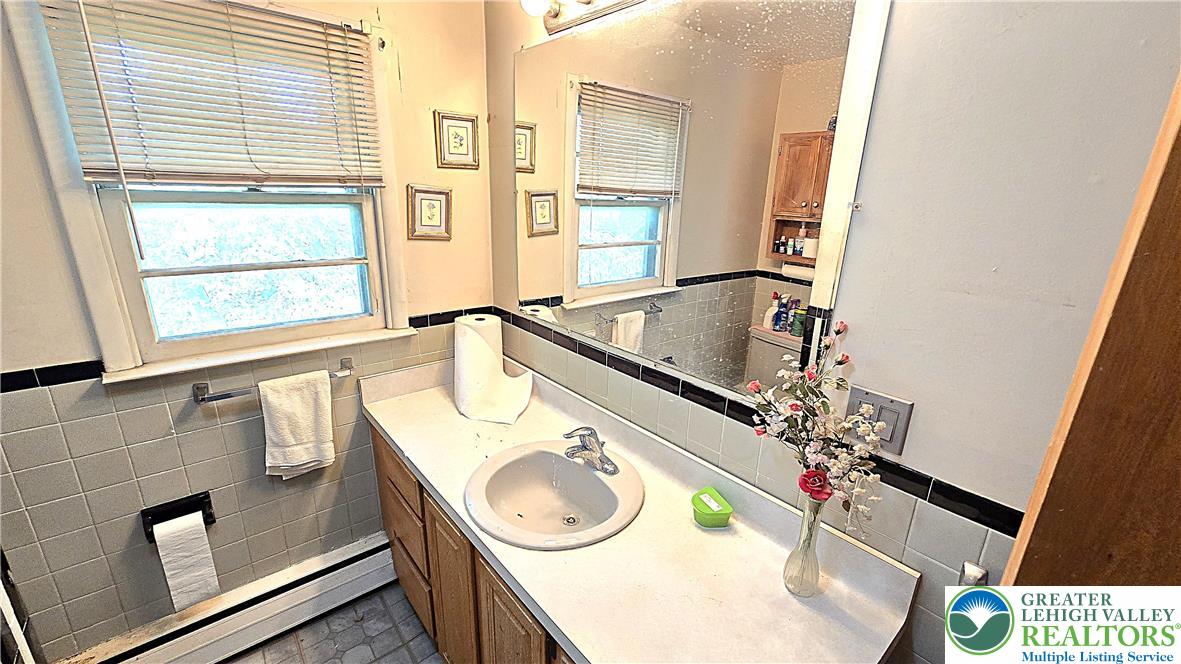 232 Virginia Avenue Whitehall, PA 18052 - Photo 19 of 26 a bathroom with a sink and a window