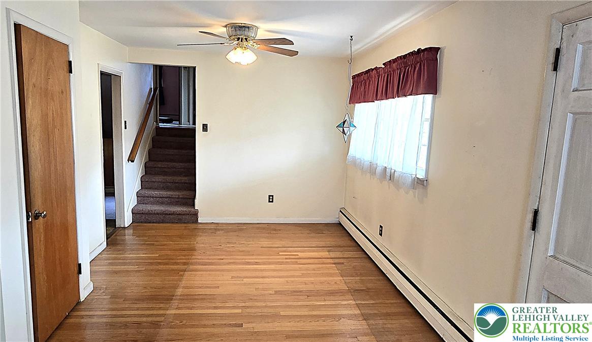 232 Virginia Avenue Whitehall, PA 18052 - Photo 7 of 26 a view of a hallway with wooden floor and staircase