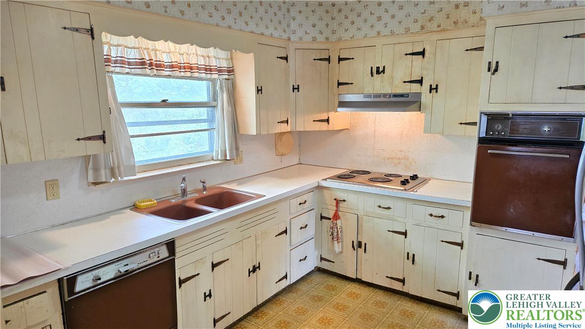 232 Virginia Avenue Whitehall, PA 18052 - Photo 10 of 26 a kitchen with granite countertop white cabinets and white appliances