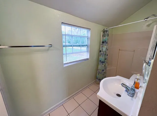 a bathroom with a sink and shower