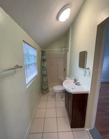 a bathroom with a sink a toilet and mirror