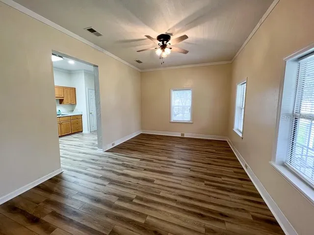 wooden floor in an empty room with a window