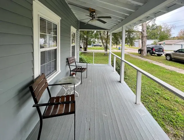 a view of a porch with furniture and garden