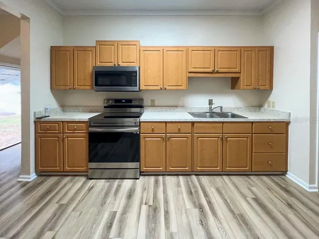 a kitchen with granite countertop a stove and cabinets