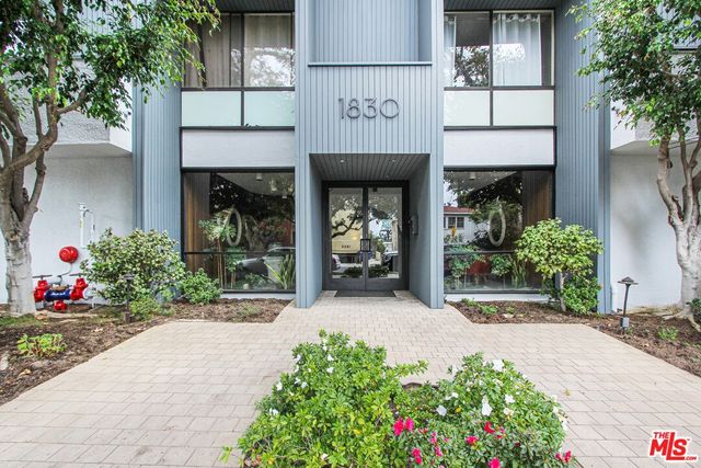 a front view of a building with flowers