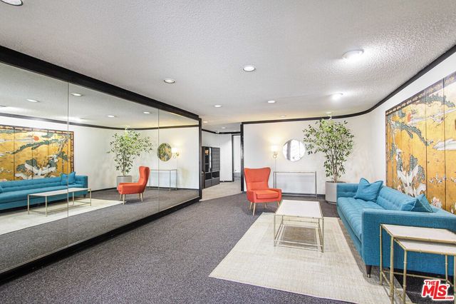 a living room with furniture a rug and a large window