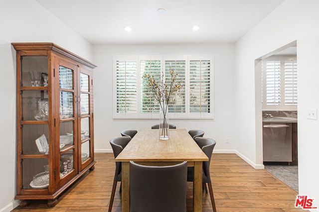 a dining room with a window and wooden floor