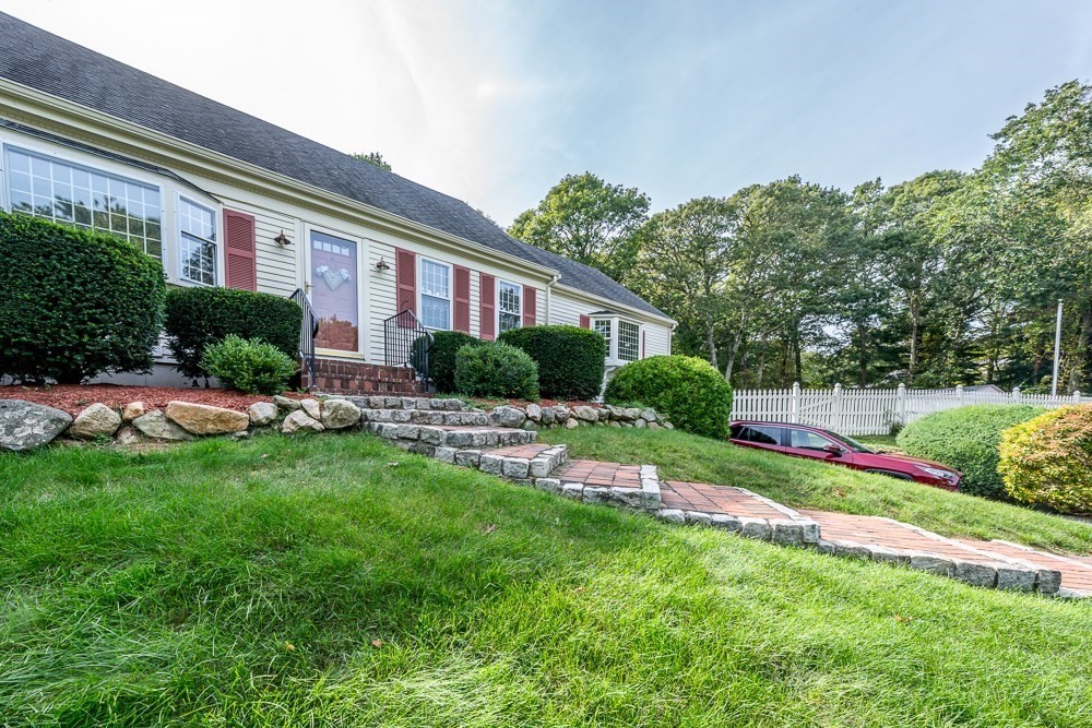 102 Wildwood Road Brewster, MA 02631 - Photo 1 of 41 a house view with a garden space