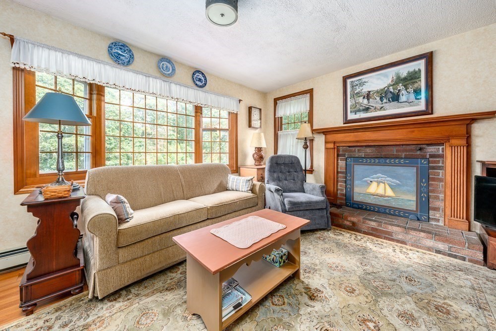 102 Wildwood Road Brewster, MA 02631 - Photo 13 of 41 a living room with furniture and a fireplace