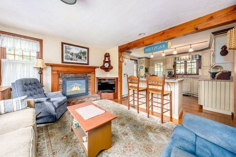 102 Wildwood Road Brewster, MA 02631 - Photo 15 of 41 a living room with furniture a flat screen tv and a fireplace