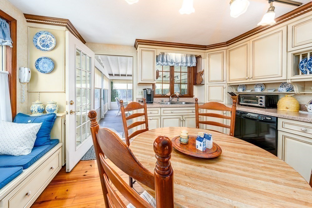 102 Wildwood Road Brewster, MA 02631 - Photo 20 of 41 a dining room with furniture and a kitchen view