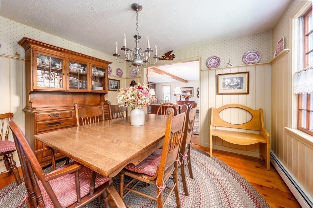 102 Wildwood Road Brewster, MA 02631 - Photo 24 of 41 a dining room with furniture a chandelier and wooden floor