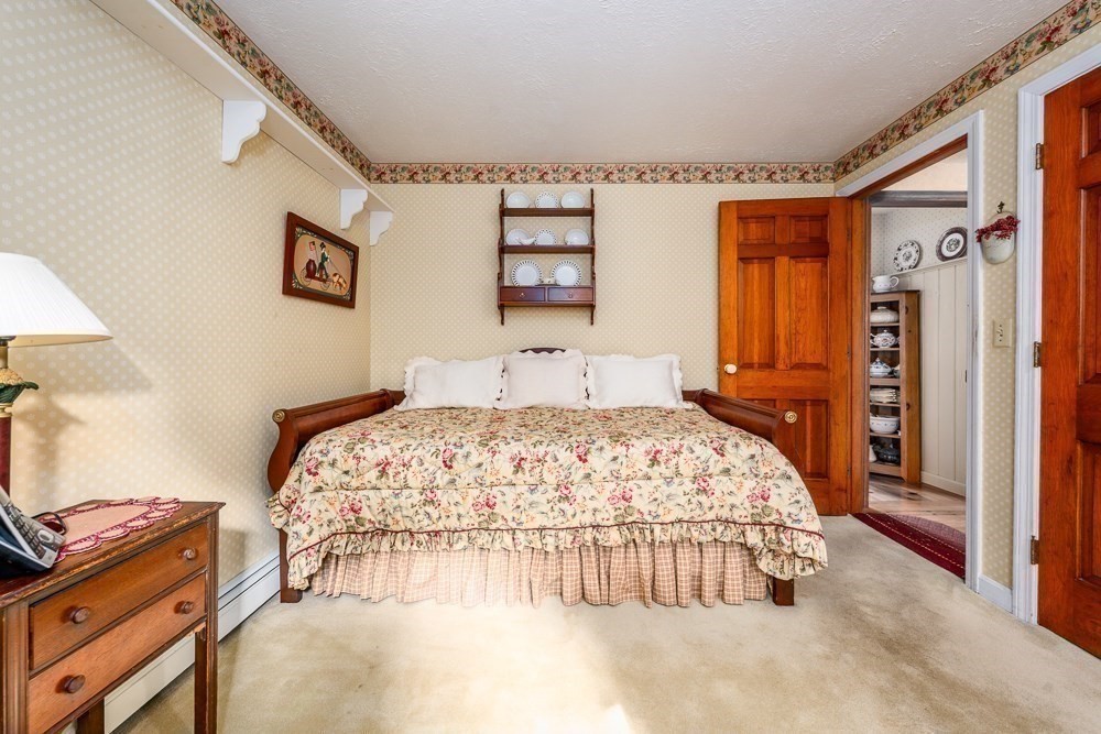 102 Wildwood Road Brewster, MA 02631 - Photo 28 of 41 a bedroom with a bed and a dresser next to a window