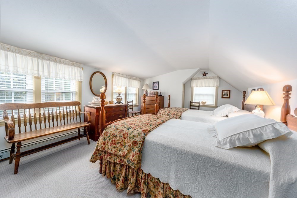 102 Wildwood Road Brewster, MA 02631 - Photo 36 of 41 a bedroom with a bed and a large window with outer view
