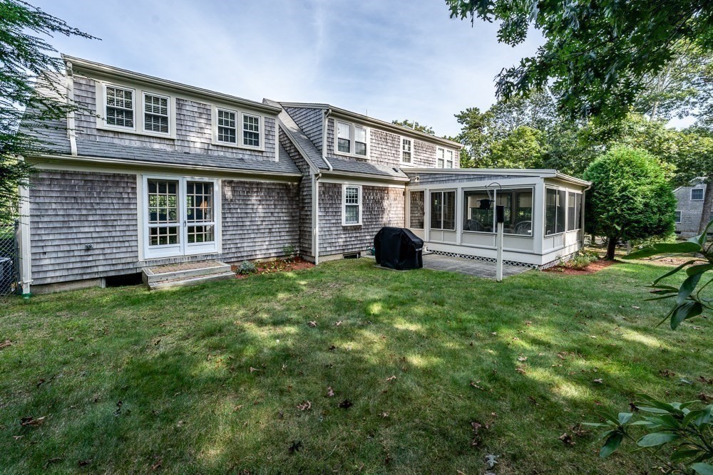 102 Wildwood Road Brewster, MA 02631 - Photo 4 of 41 a view of a house with a yard and plants