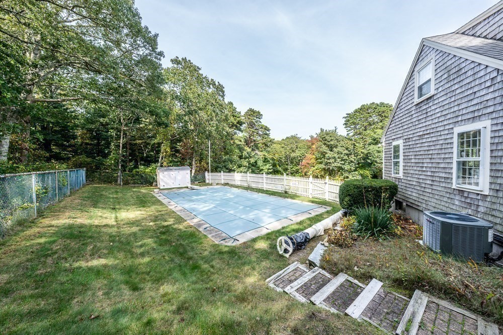 102 Wildwood Road Brewster, MA 02631 - Photo 5 of 41 a view of backyard with swimming pool and outdoor seating
