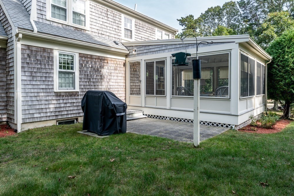 102 Wildwood Road Brewster, MA 02631 - Photo 6 of 41 a view of a house with a garden