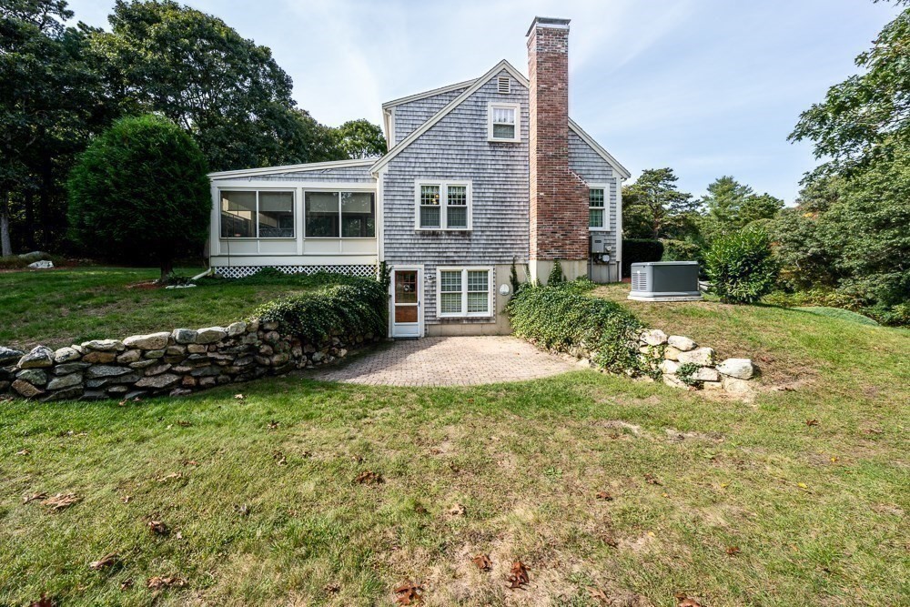 102 Wildwood Road Brewster, MA 02631 - Photo 9 of 41 a front view of a house with a yard