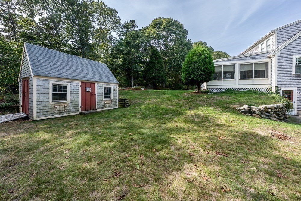 102 Wildwood Road Brewster, MA 02631 - Photo 10 of 41 a view of a house with a backyard