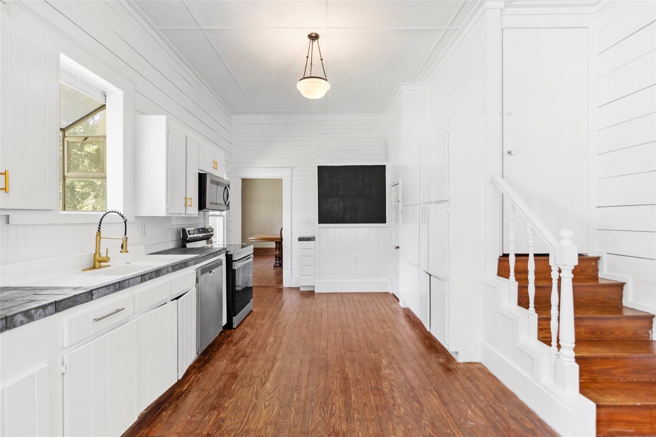 38 Darrell White Road Huntsville, TX 77340 - Photo 11 of 49 a large kitchen with a sink and wooden floor