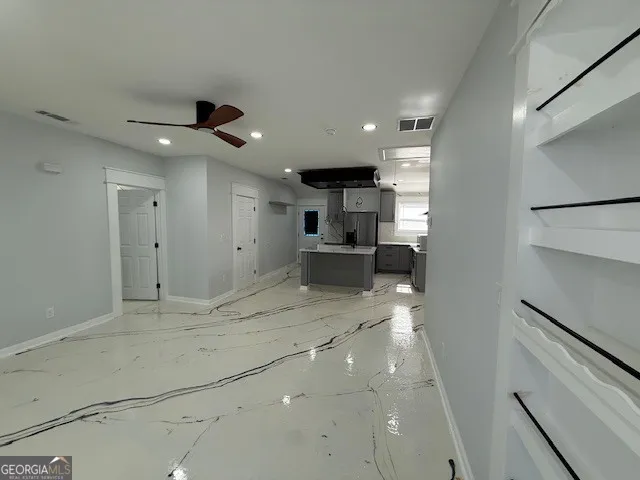 a view of kitchen with refrigerator and window