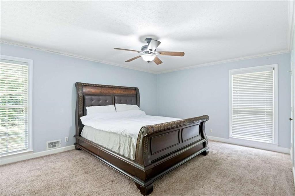 140 Old Fairburn Close Southwest South Fulton, GA 30331 - Photo 12 of 28 a bedroom with a bed and a ceiling fan