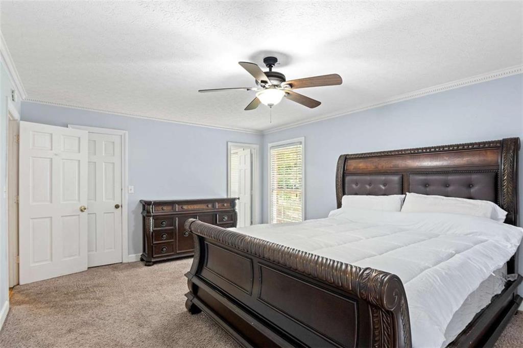 140 Old Fairburn Close Southwest South Fulton, GA 30331 - Photo 13 of 28 a bedroom with a bed and a chandelier