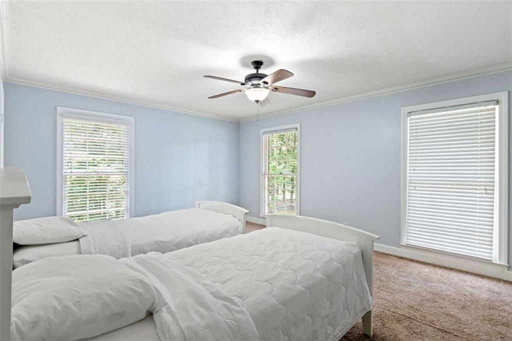 140 Old Fairburn Close Southwest South Fulton, GA 30331 - Photo 15 of 28 a bedroom with two beds and a window