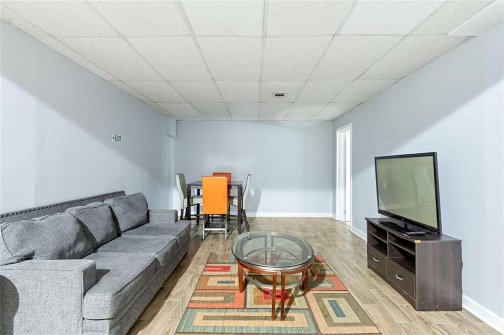 140 Old Fairburn Close Southwest South Fulton, GA 30331 - Photo 17 of 28 a living room with furniture a flat screen tv and a table
