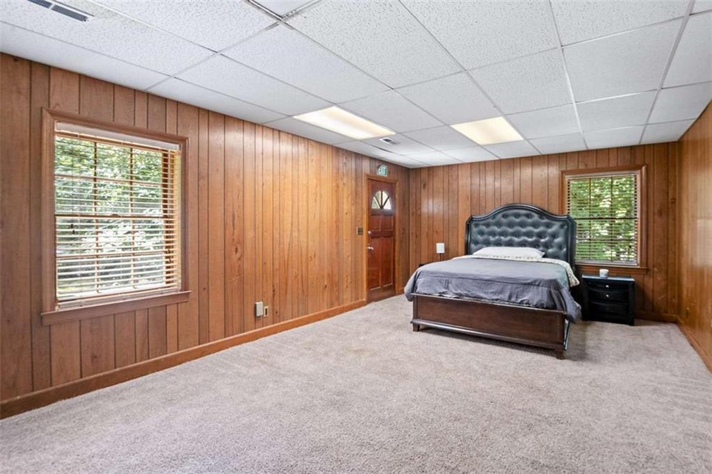 140 Old Fairburn Close Southwest South Fulton, GA 30331 - Photo 18 of 28 a bedroom with a large bed and a large window