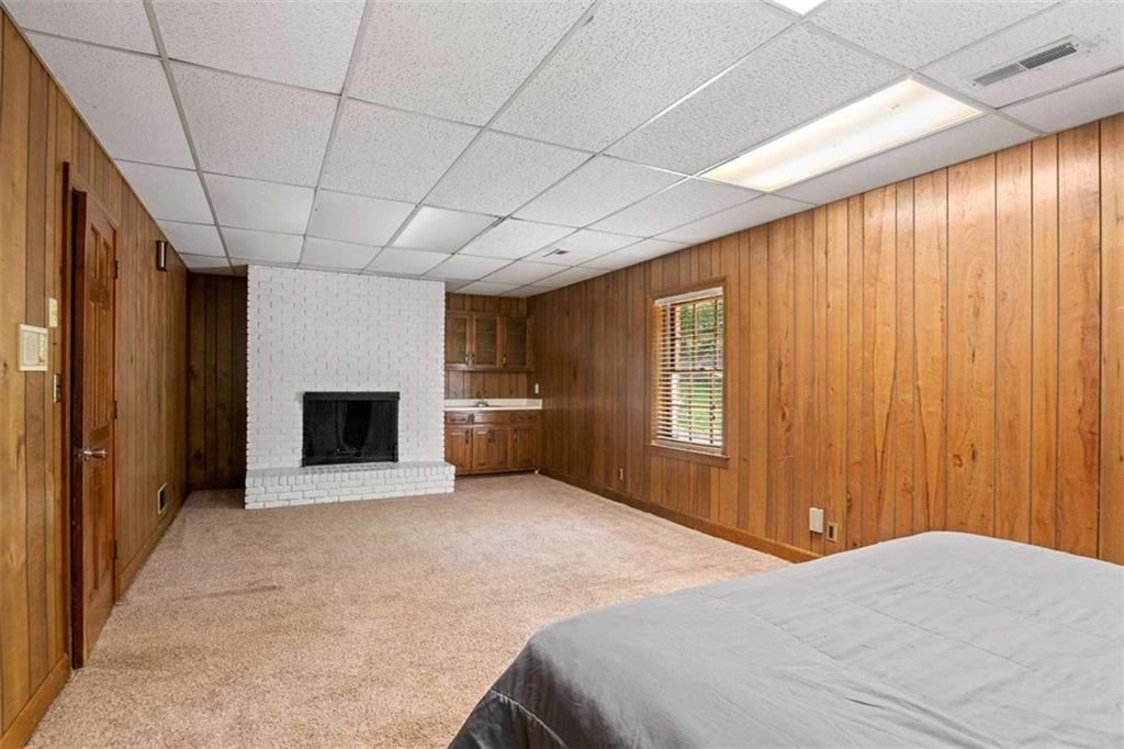 140 Old Fairburn Close Southwest South Fulton, GA 30331 - Photo 19 of 28 a spacious bedroom with a large bed and a chandelier