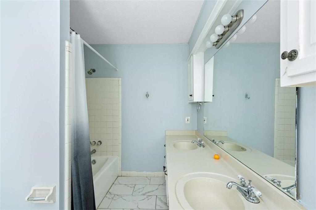 140 Old Fairburn Close Southwest South Fulton, GA 30331 - Photo 23 of 28 a bathroom with a sink and mirror with bathtub