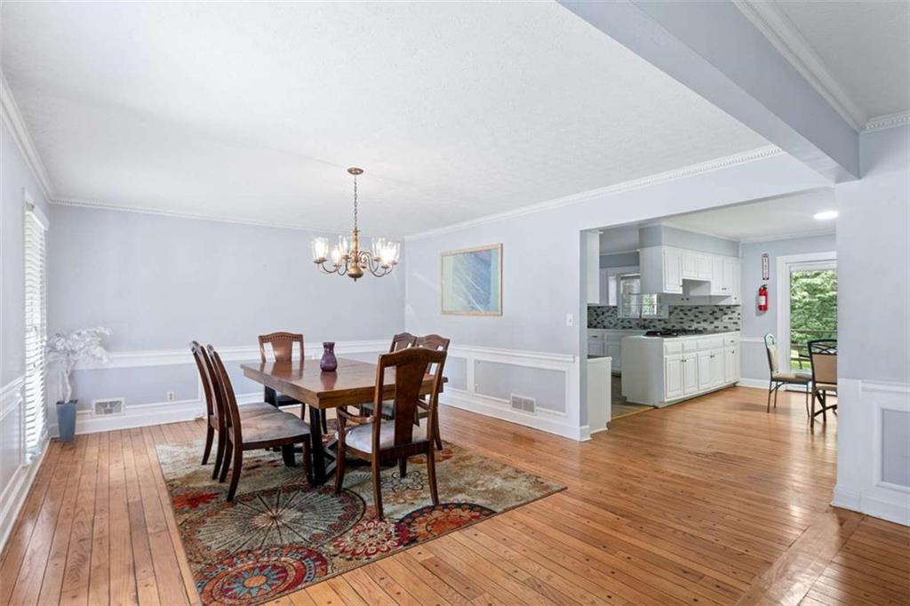 140 Old Fairburn Close Southwest South Fulton, GA 30331 - Photo 5 of 28 a view of a dining room with furniture and wooden floor