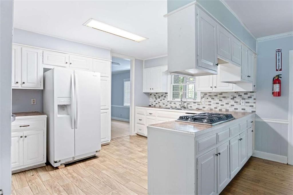 140 Old Fairburn Close Southwest South Fulton, GA 30331 - Photo 6 of 28 a kitchen with white cabinets and white appliances