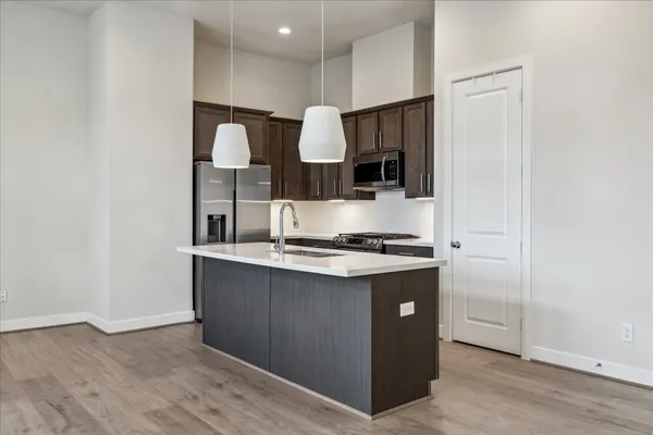 a kitchen with stainless steel appliances granite countertop a stove and a refrigerator