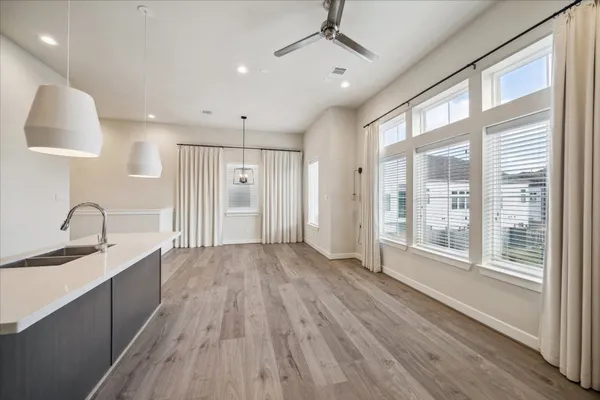 a view of a kitchen with a sink and wooden floor