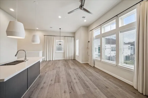 a view of a kitchen with a sink and a large window