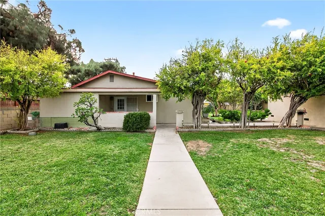 a living room with furniture a flat screen tv and a window