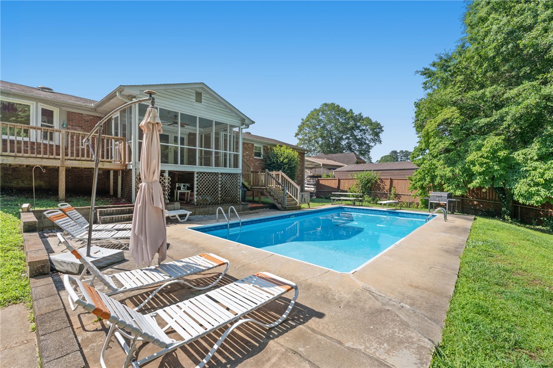 200 Echo Circle Easley, SC 29642 - Photo 4 of 35 An inviting backyard oasis offers a sparkling in-ground pool, perfect for sunny day relaxation.