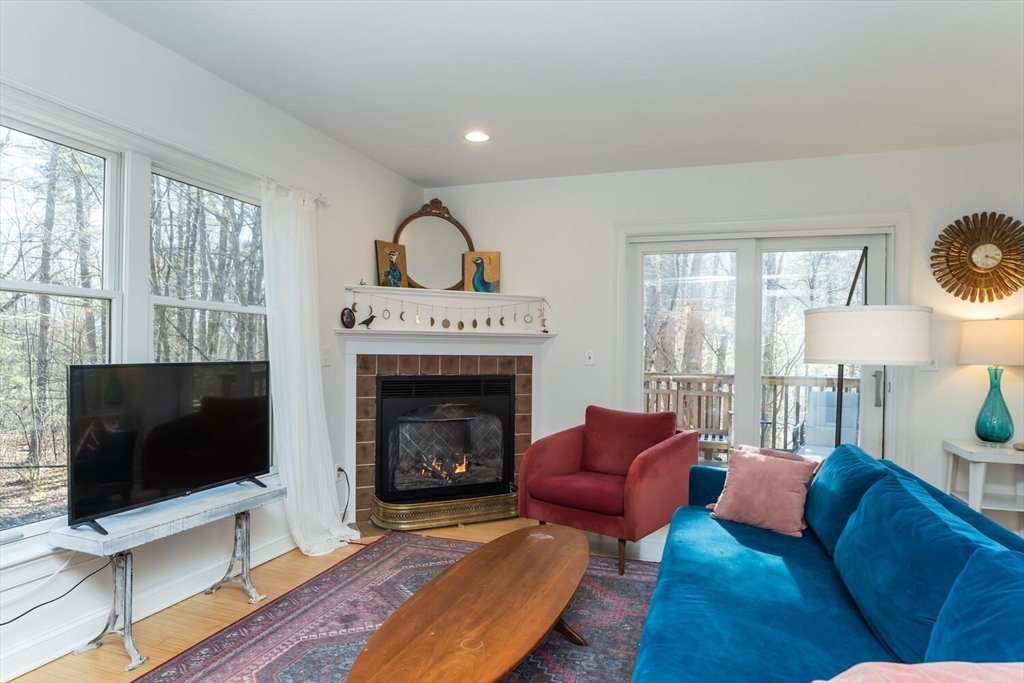 642 North Farms Road Northampton, MA 01062 - Photo 15 of 42 a living room with furniture a flat screen tv and a fireplace