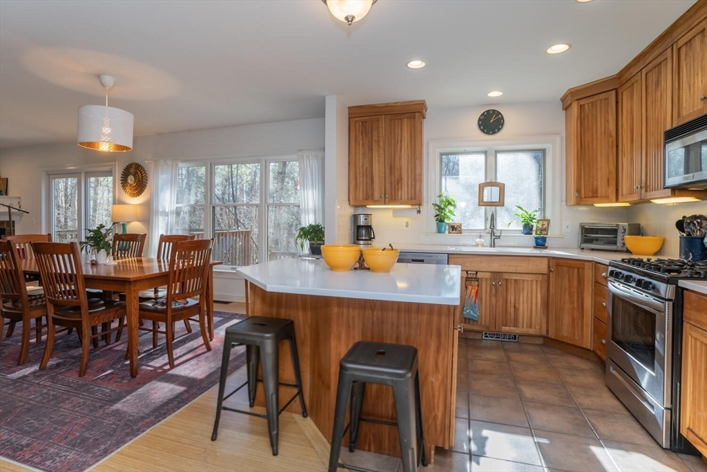 642 North Farms Road Northampton, MA 01062 - Photo 7 of 42 a kitchen with a table chairs sink and cabinets